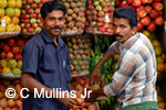 Indian fruit vendor serving customer on the street